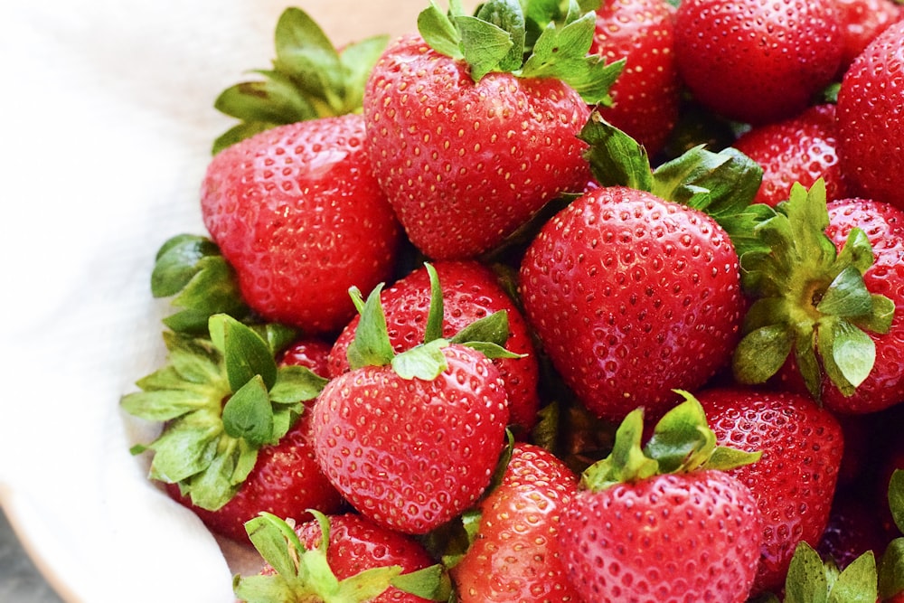 strawberries on white bowl