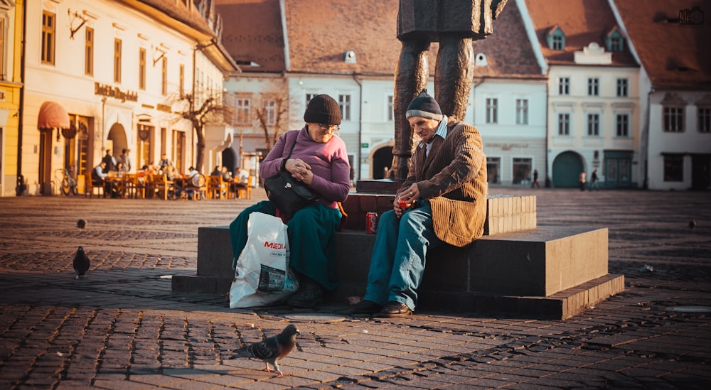 woman sitting beside men near statue