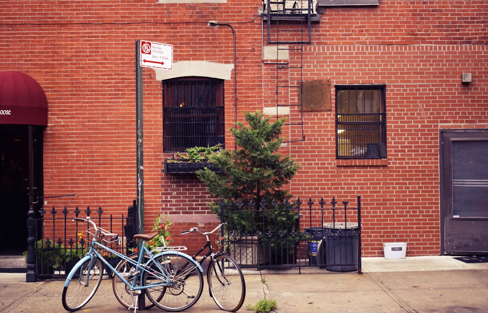 two city bikes parked in front of house