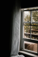Close-up of a sleek modern window frame with raindrops on the glass.