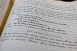 Close-up of an open book showing a famous Greek short story with handwritten notes.