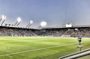 Action shot of a soccer match under bright stadium lights in Sprockhövel.