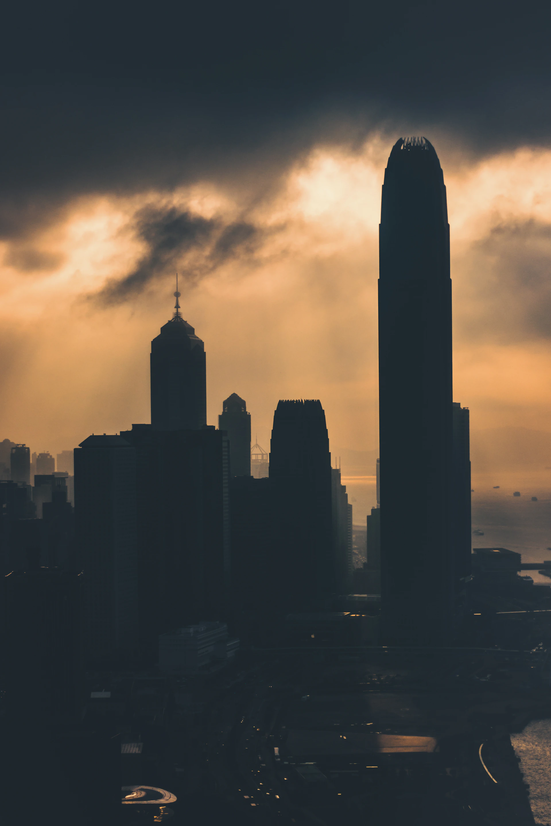A cinematic frame showing a dramatic sunset over a city skyline, highlighting warm golden tones and deep shadows.