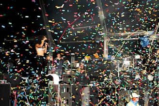 An entertainer performing on stage, captivating an excited crowd at a lively celebration.