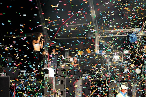 An entertainer performing on stage, captivating an excited crowd at a lively celebration.