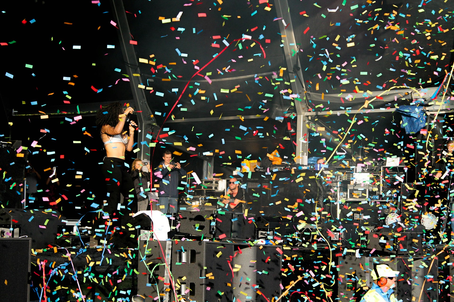 An inviting scene showcasing a stage with a performer entertaining a crowd, capturing the excitement of a live event.