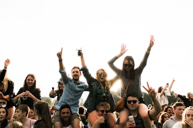 photography poses for big groups,how to photograph three men carrying women surrounded by many people during daytime
