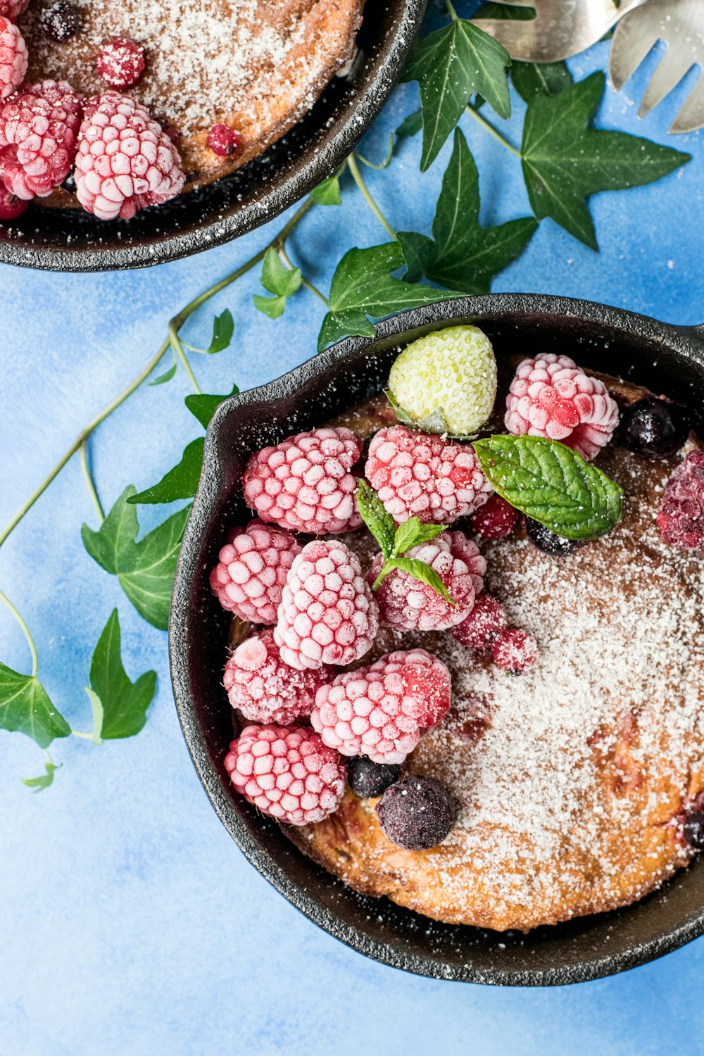 raspberries on black bowl