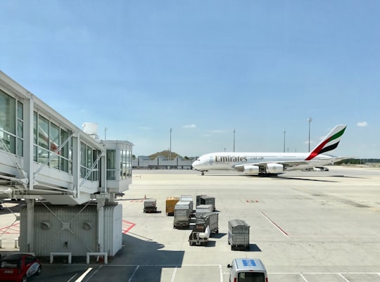 white Emirates airplane on airport in Munich International Airport Germany