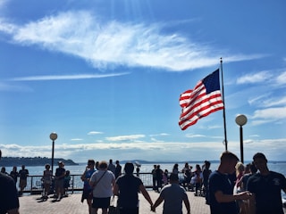 A group of Fairfield Harbour residents gathered outdoors discussing community matters on a sunny day.