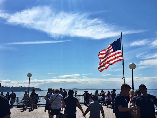 A welcoming community gathering during an Independence Day celebration under bright blue skies.