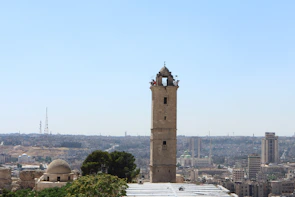 The historic Hassan Tower standing tall against a clear blue sky.