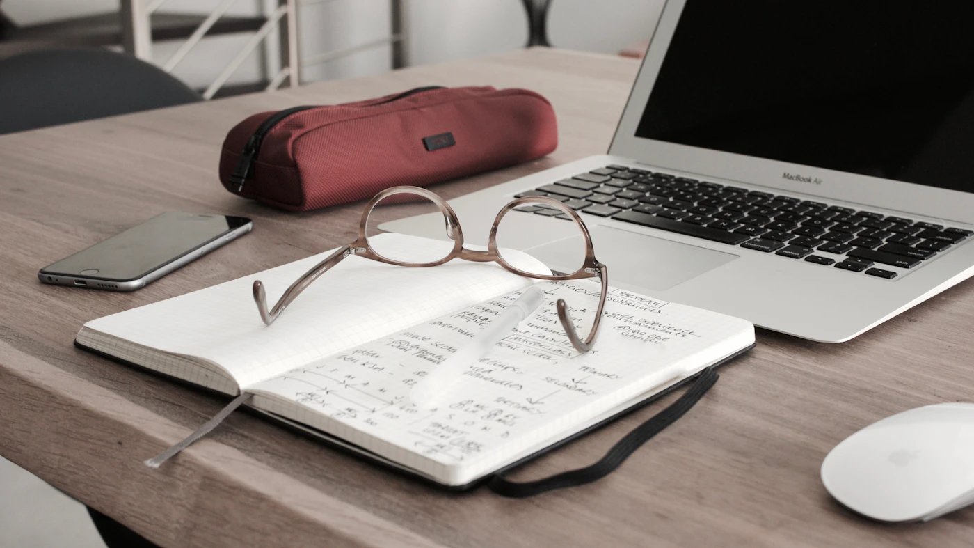 Notebook and laptop arranged for focused analysis
