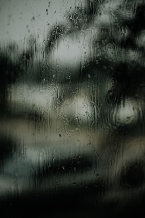 macro photography of water droplets on clear glass