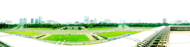 Panoramic view of a mixed-use development blending modern architecture with green spaces.