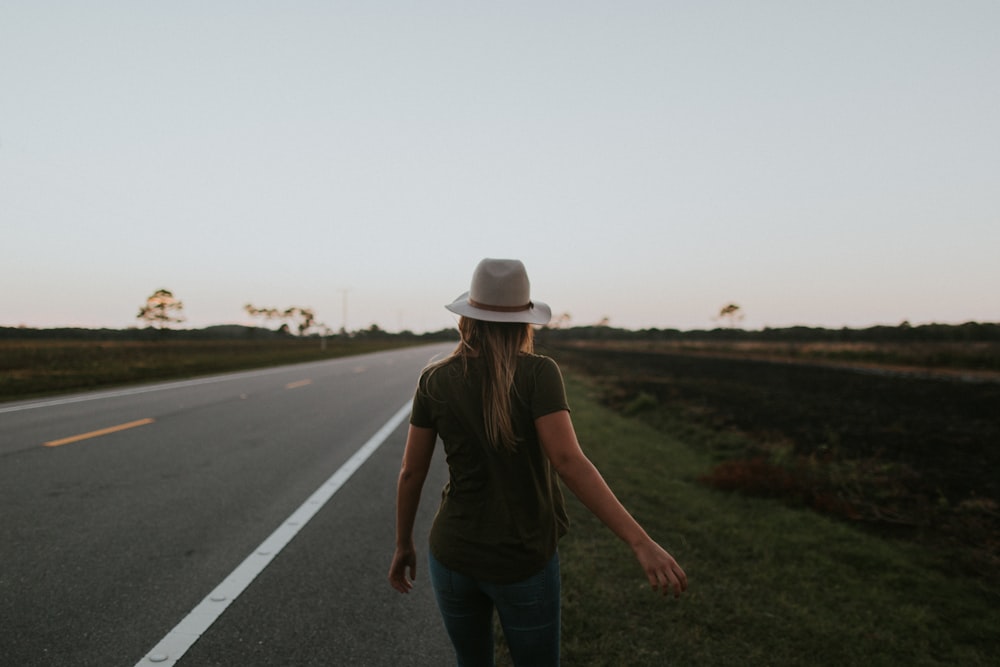 woman walking on side of the road