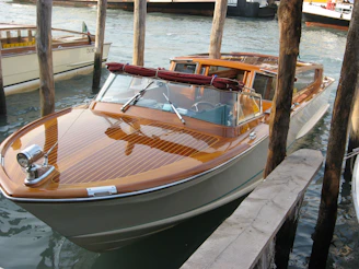 A sleek boat displayed on water, highlighting the sales service.