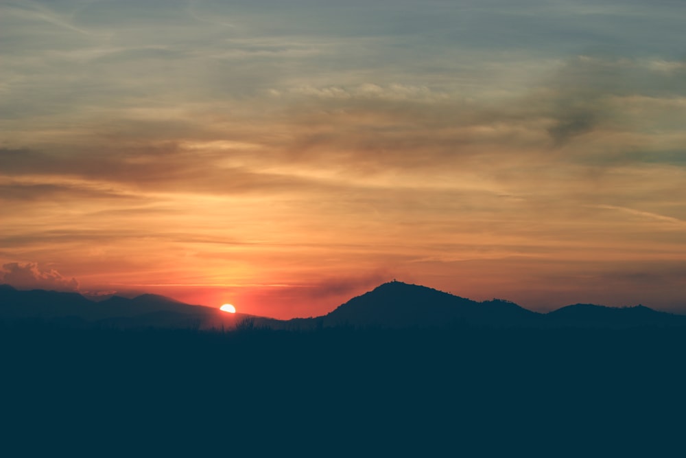 silhouette of mountains during golden hour photography