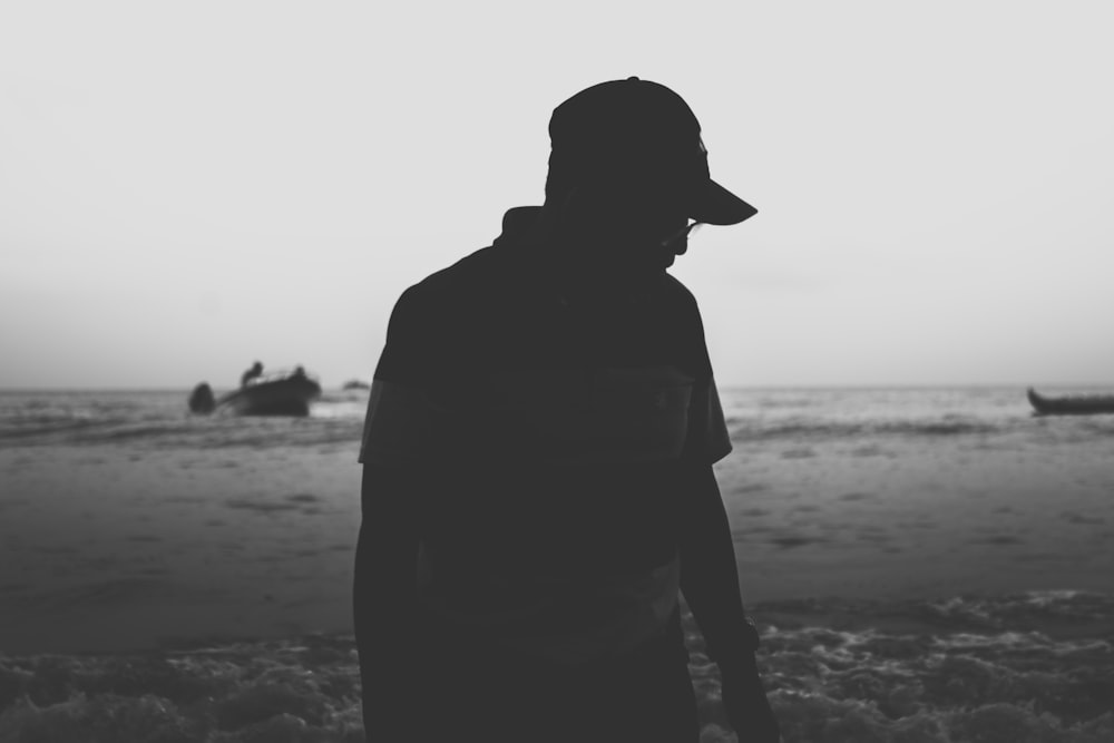 silhouette photo of person in cap