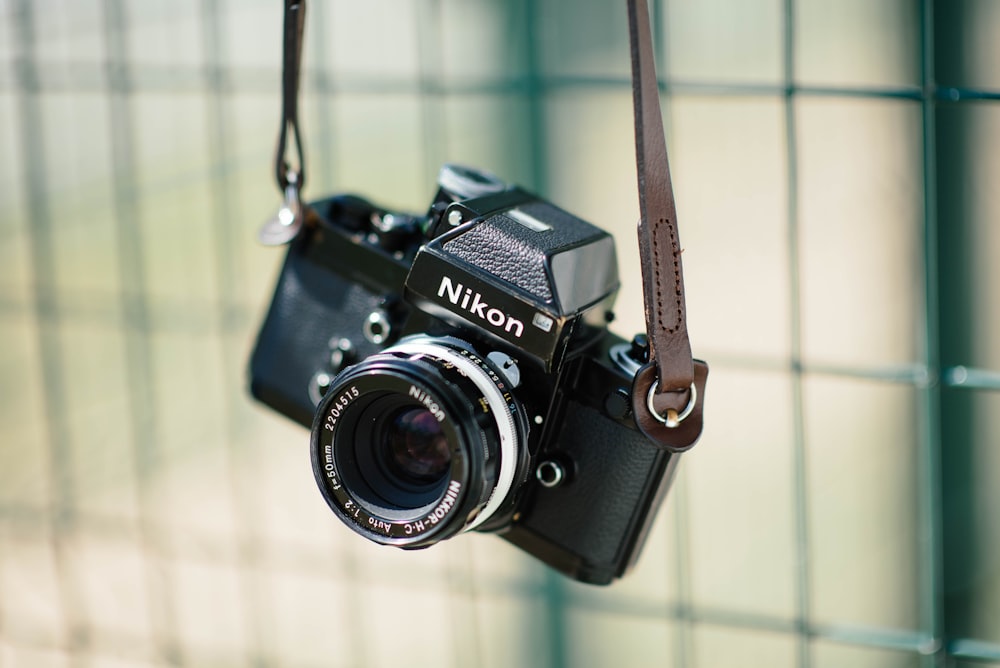 selective focus photography of classic Nikon SLR camera