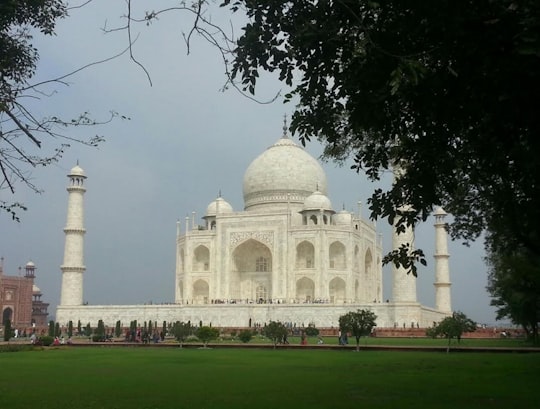 white concrete mosque near grass field in Taj Mahal India