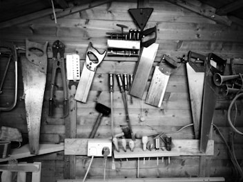 grayscale photography of arranged assorted hand tools