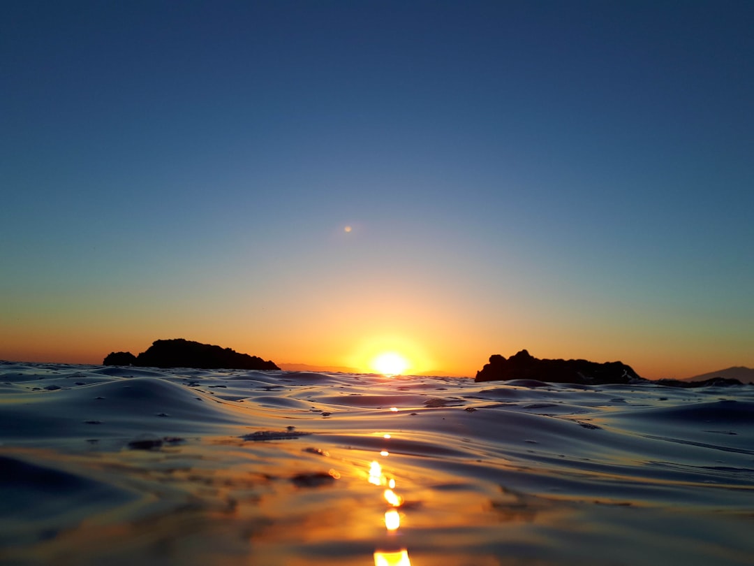 body of water during sunset