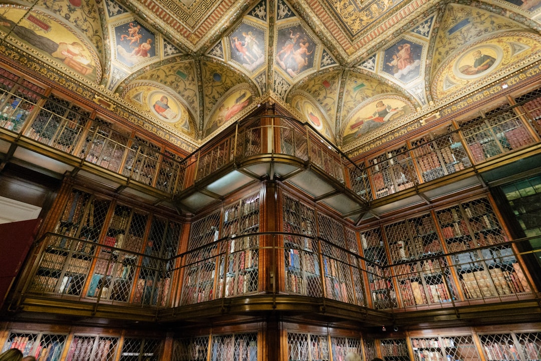 low-angle photography of brown 2-storey structure, ornate ceiling morgan library