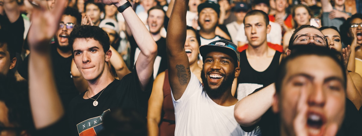 people in crowd cheering