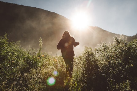 silhouette photo of person walking on the field