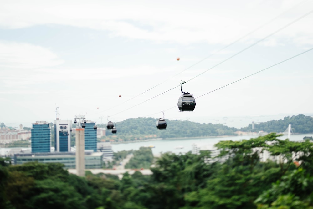 four white cable cars near blue building