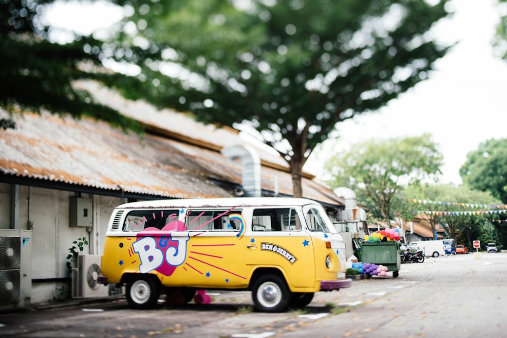 yellow and white Volkswagen Kombi parked near white building