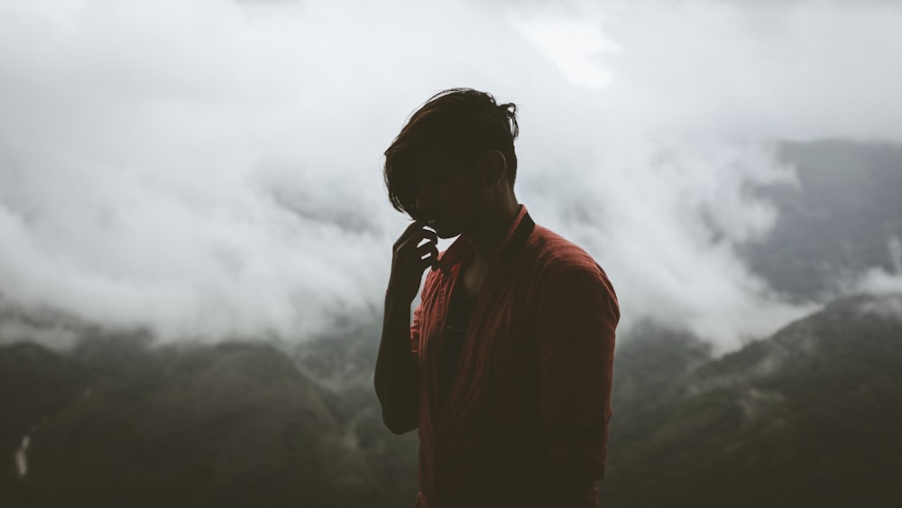 person standing in front of green mountains during daytime