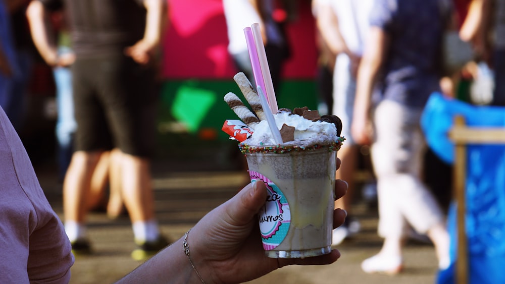 person holding ice cream cup