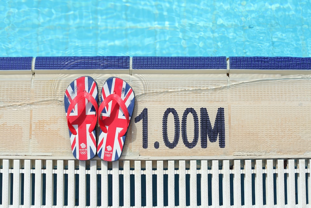 pair of red, blue, and black Union Jack flip-flops