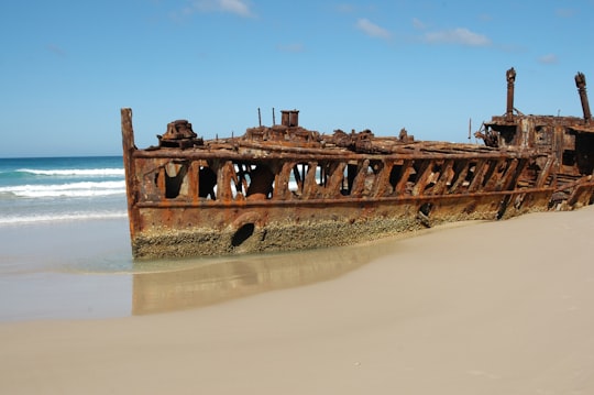 ship wreck docked on beach during day time in Fraser Island Australia