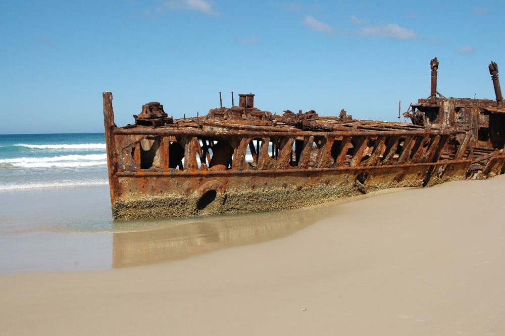 ship wreck docked on beach during day time
