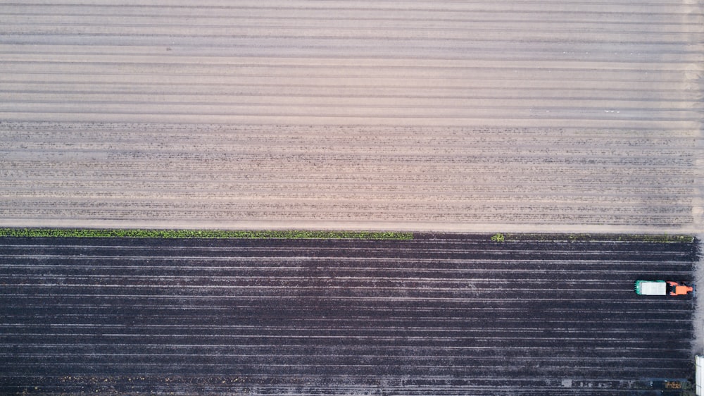 an aerial view of a farm field with a tractor