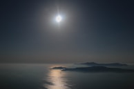 A serene outdoor scene with sunlight reflecting off gold jewelry.