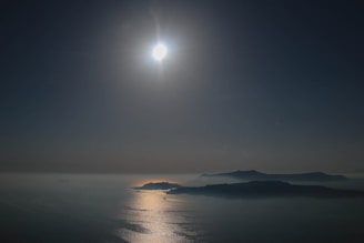 A serene outdoor scene with sunlight reflecting off gold jewelry.