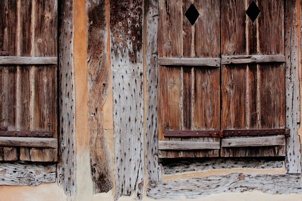 an old wooden building with two wooden doors