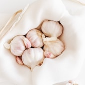 five garlic on white textile