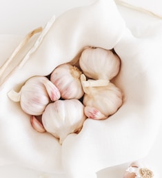 five garlic on white textile