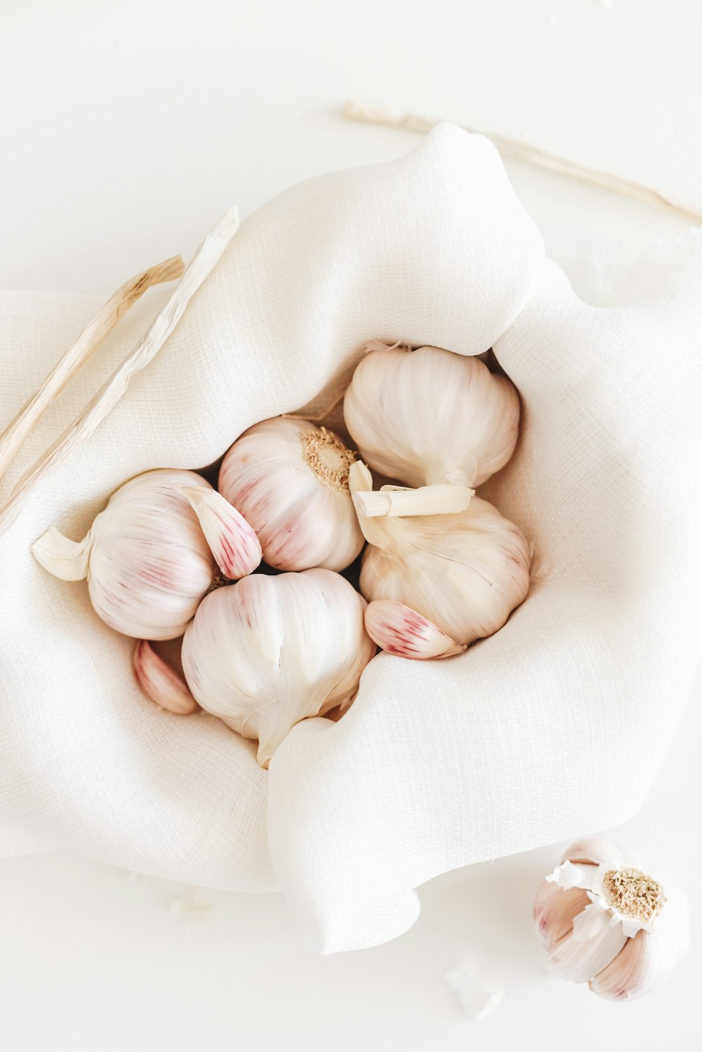 five garlic on white textile