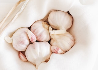 five garlic on white textile