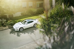 white coupe parked near house