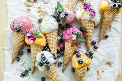 coned ice cream with blueberries and flowers sweet teams background