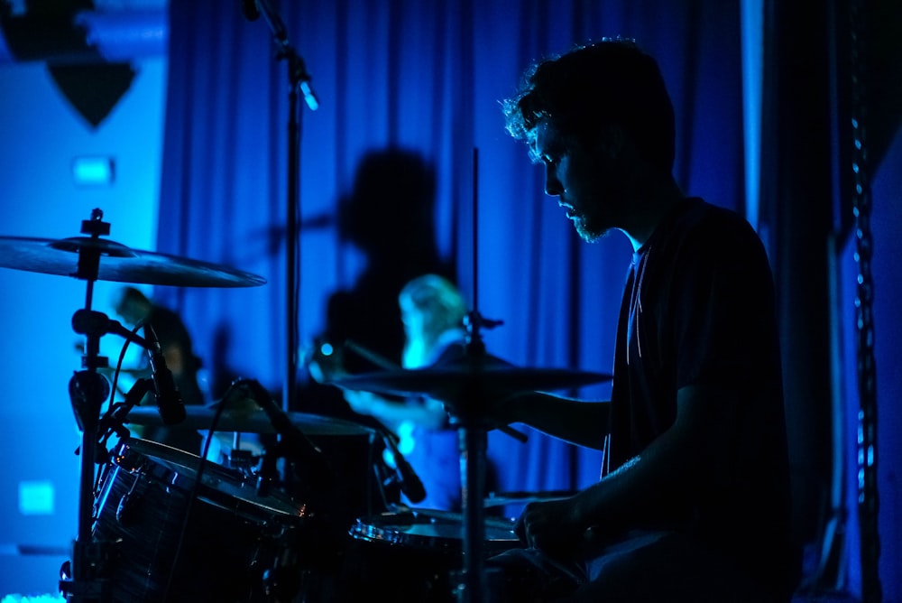 man playing drum set