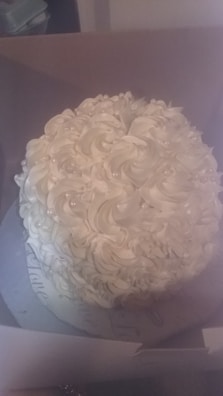 A whimsical cake with pastel swirls and tiny edible pearls, perfect for a joyful celebration.