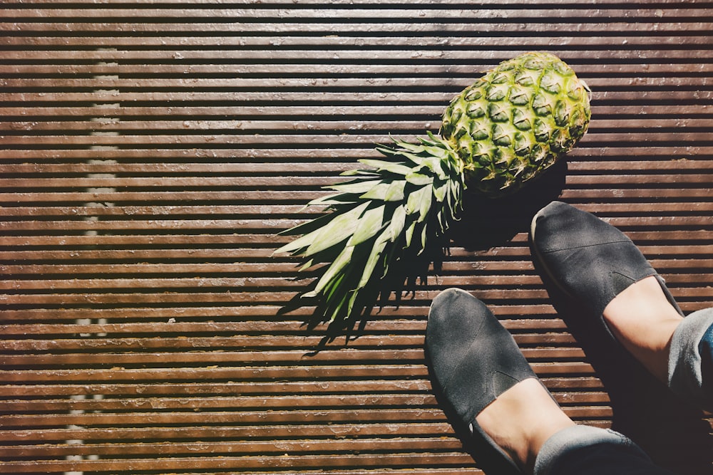pineapple beside person's feet